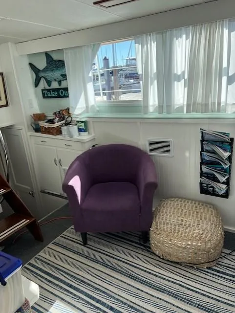 Slide: The Image of Interior of 1971 Hatteras 43 Double Cabin with purple chair and nautical decor. - 20