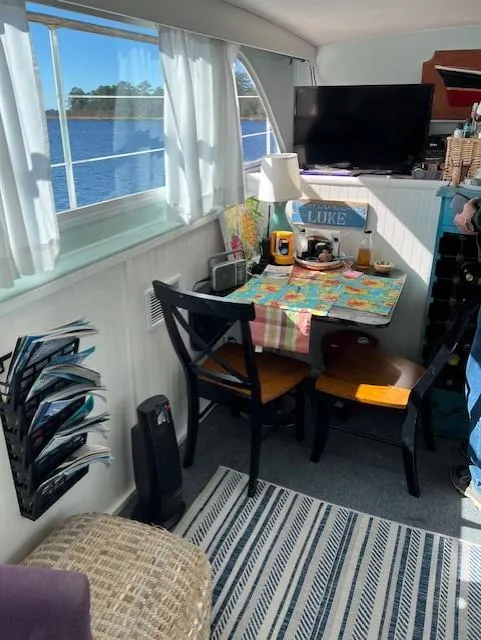 Slide: The Image of Interior of 1971 Hatteras 43 Double Cabin with cozy dining area and nautical decor. - 21