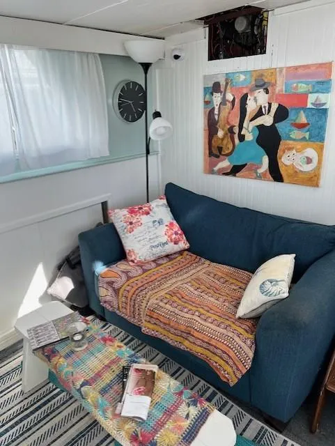 Slide: The Image of Cozy interior of 1971 Hatteras 43 Double Cabin with colorful decor and artwork. - 22