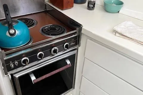 Slide: The Image of Vintage stove and kettle in 1971 Hatteras 43 Double Cabin kitchen. - 25