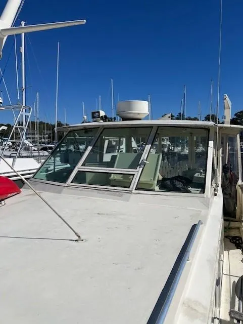 Slide: The Image of 1971 Hatteras 43 Double Cabin yacht docked in marina under clear blue sky. - 6