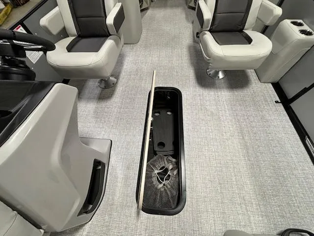 Slide: The Image of 2024 Harris Cruiser 210 CWDH interior with open storage compartment. - 11