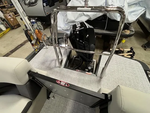 Slide: The Image of 2024 Harris Cruiser 210 CWDH pontoon boat with outboard motor in a showroom. - 14