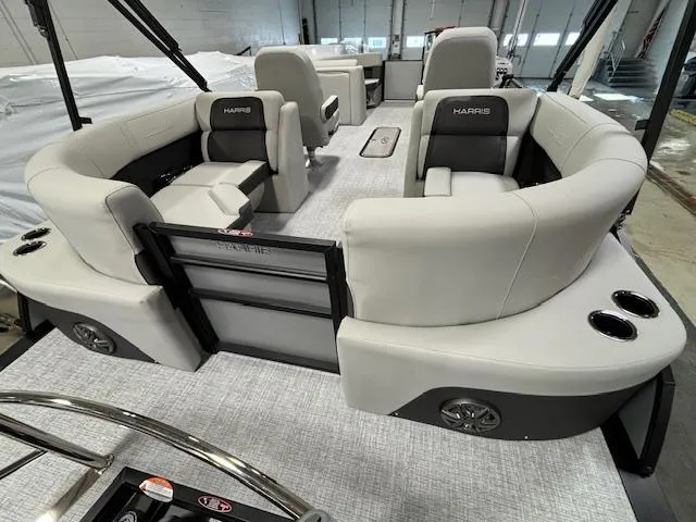 Slide: The Image of 2024 Harris Cruiser 210 CWDH pontoon boat interior with plush seating and cup holders. - 15