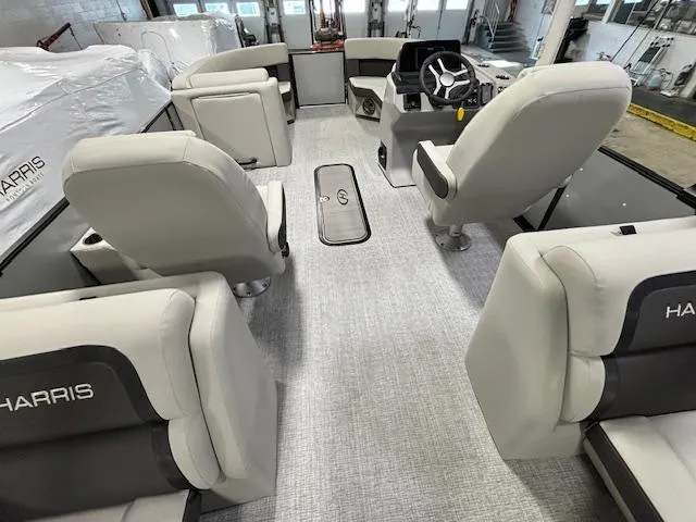 Slide: The Image of 2024 Harris Cruiser 210 CWDH pontoon boat interior with plush seating and modern helm. - 17