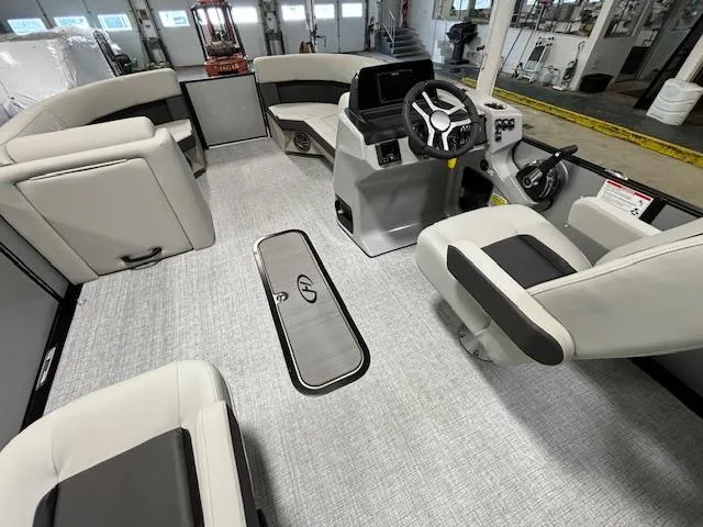 Slide: The Image of Interior of 2024 Harris Cruiser 210 CWDH pontoon boat with modern seating and steering console. - 18