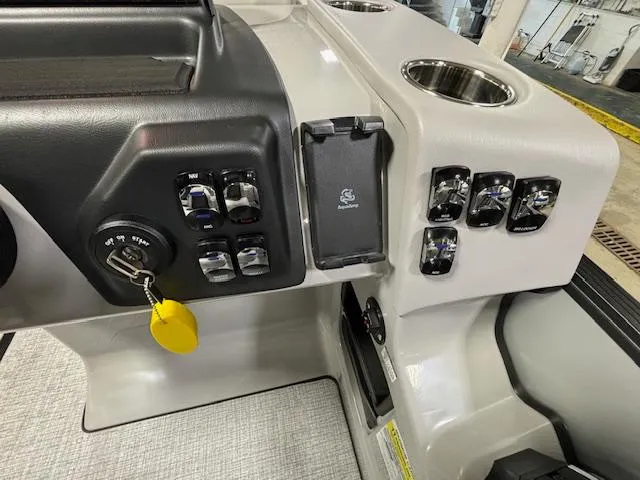 Slide: The Image of Control panel of 2024 Harris Cruiser 210 CWDH boat with key ignition and switches. - 20