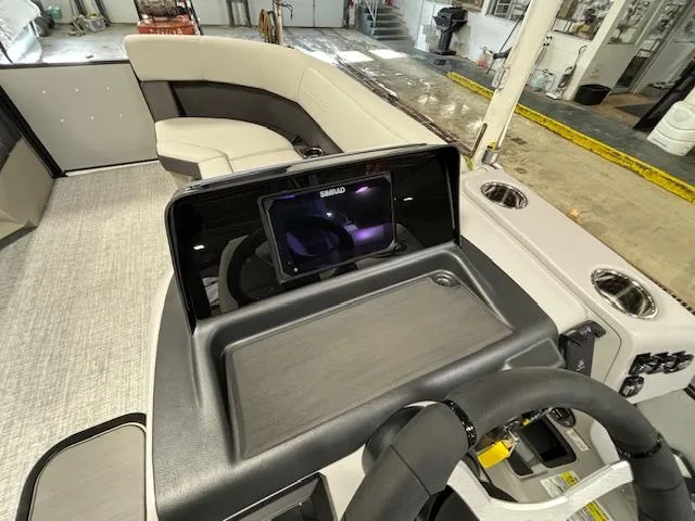 Slide: The Image of 2024 Harris Cruiser 210 CWDH boat interior with modern dashboard and seating. - 21