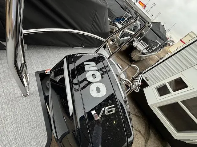 Slide: The Image of 2024 Harris Cruiser 210 CWDH with Mercury 200 V6 engine. - 5