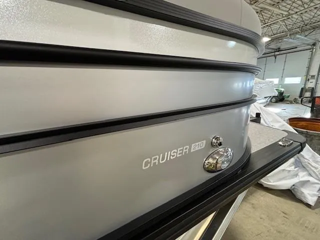 Slide: The Image of 2024 Harris Cruiser 210 CWDH pontoon boat in a warehouse. - 7