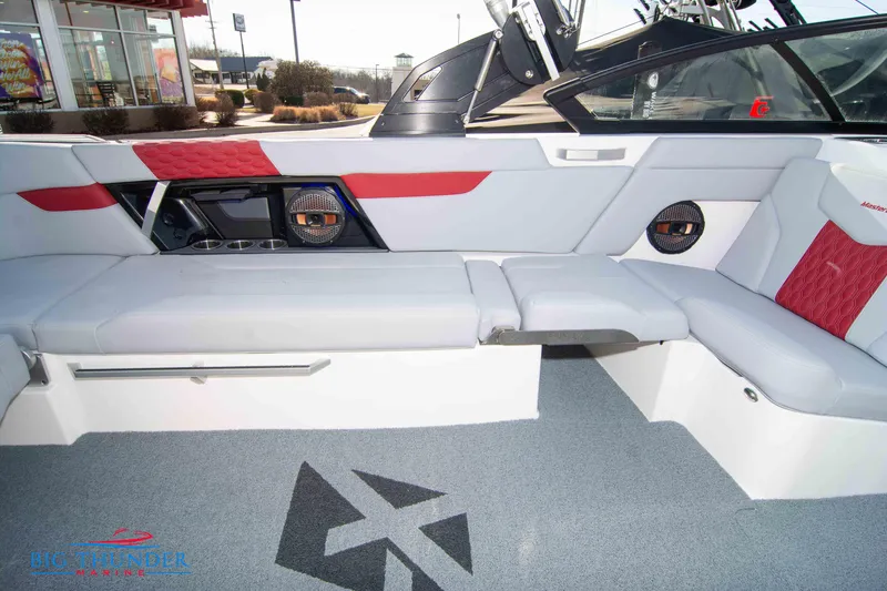 Slide: The Image of 2024 MasterCraft XT25 boat interior with red and white seating and modern design. - 19