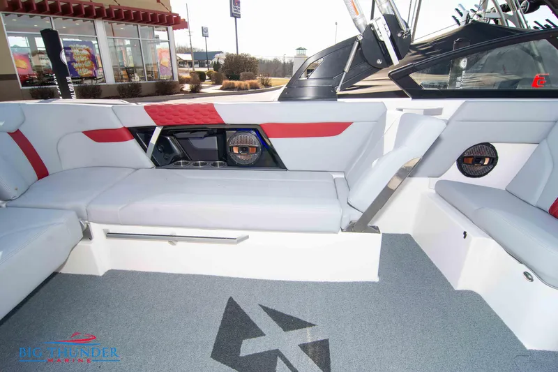 Slide: The Image of 2024 MasterCraft XT25 boat interior with red and white seating, speakers, and modern design. - 20