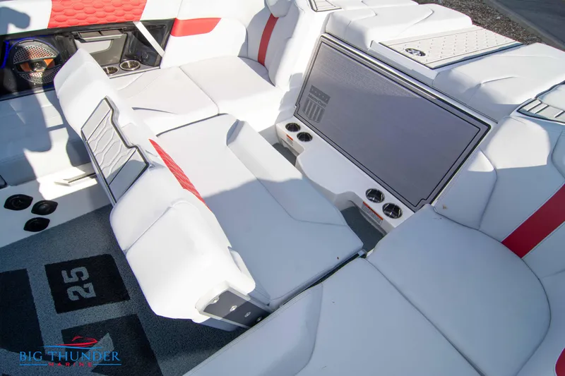 Slide: The Image of 2024 MasterCraft XT25 boat interior with white and red seating. - 22