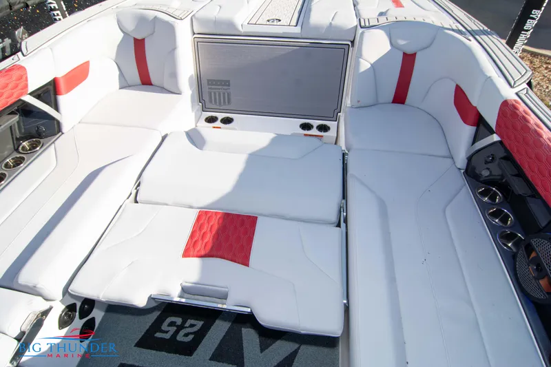 Slide: The Image of 2024 MasterCraft XT25 boat interior with white and red seating. - 23