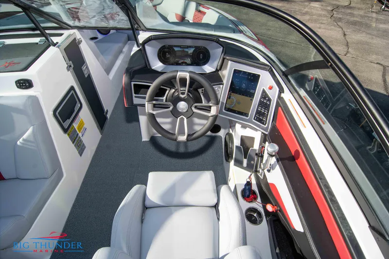 Slide: The Image of 2024 MasterCraft XT25 boat cockpit with modern steering and navigation controls. - 28