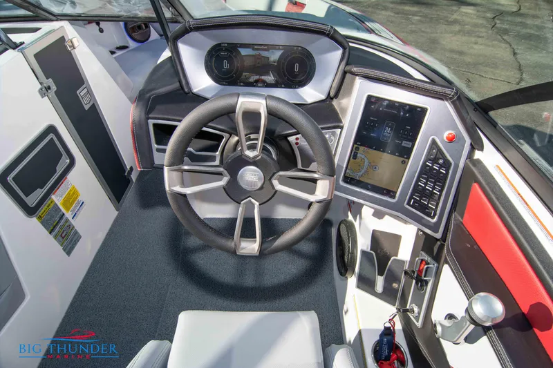 Slide: The Image of 2024 MasterCraft XT25 boat dashboard with steering wheel and touchscreen controls. - 29