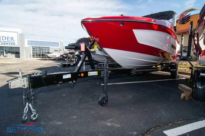 Slide: The Image of 2024 MasterCraft XT25 boat on a trailer at a dealership. - 3