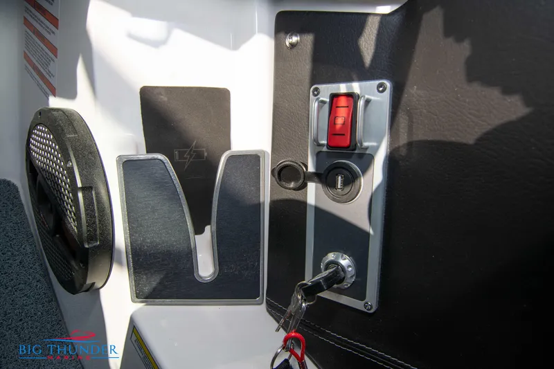 Slide: The Image of 2024 MasterCraft XT25 boat dashboard with ignition key and control panel. - 33