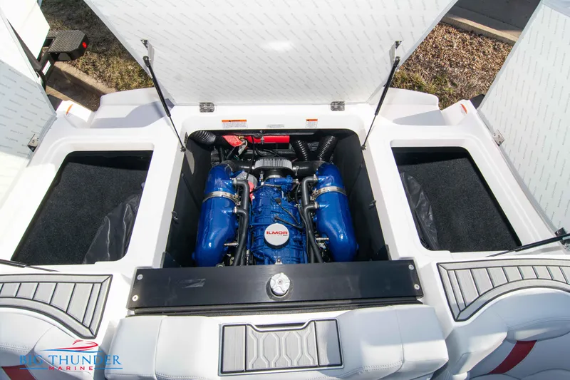 Slide: The Image of 2024 MasterCraft XT25 boat engine compartment with open hatches. - 49
