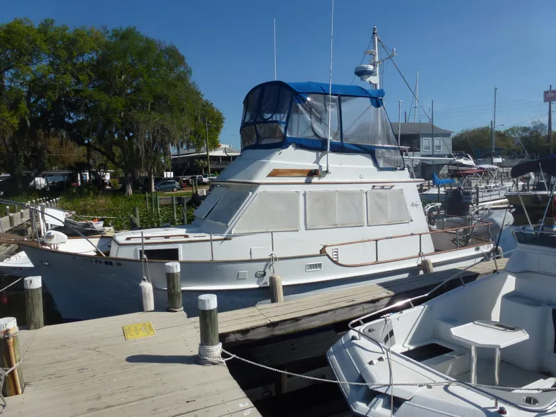 Slide: The Image of 1983 Island Gypsy Trawler docked at a marina on a sunny day. - 26
