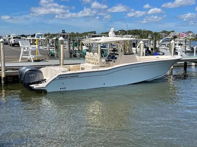 The Image of 2022 Grady-White Canyon 326 boat docked at a marina on a sunny day. - 0