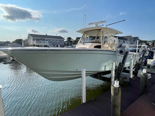 Slide: The Image of 2022 Grady-White Canyon 326 boat docked at a marina. - 2