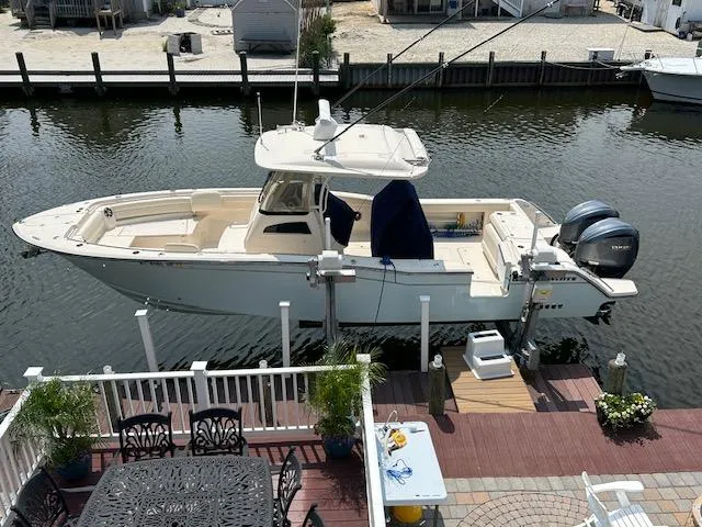 Slide: The Image of 2022 Grady-White Canyon 326 boat docked at a waterfront deck. - 3
