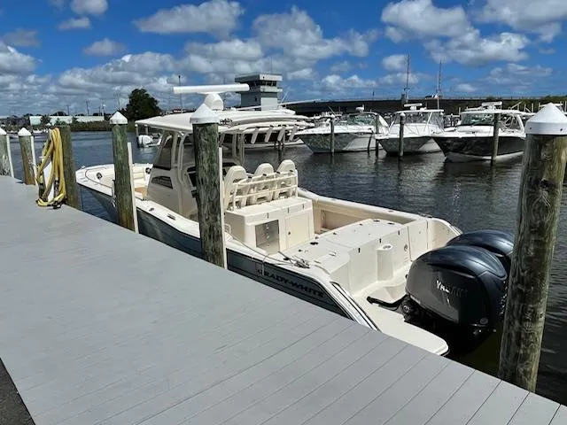 Slide: The Image of 2022 Grady-White Canyon 326 boat docked at a marina on a sunny day. - 4