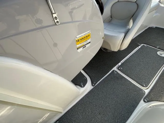 Slide: The Image of 2005 Chaparral 216 SUNSETTA boat interior with seating and carpeted floor. - 10