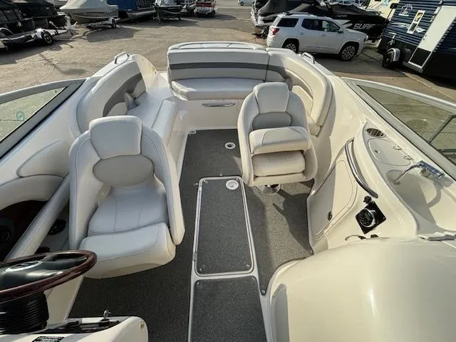 Slide: The Image of 2005 Chaparral 216 SUNSETTA boat interior with white seating and gray flooring. - 11