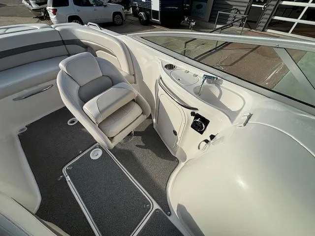 Slide: The Image of 2005 Chaparral 216 SUNSETTA boat interior with seating and control panel. - 12