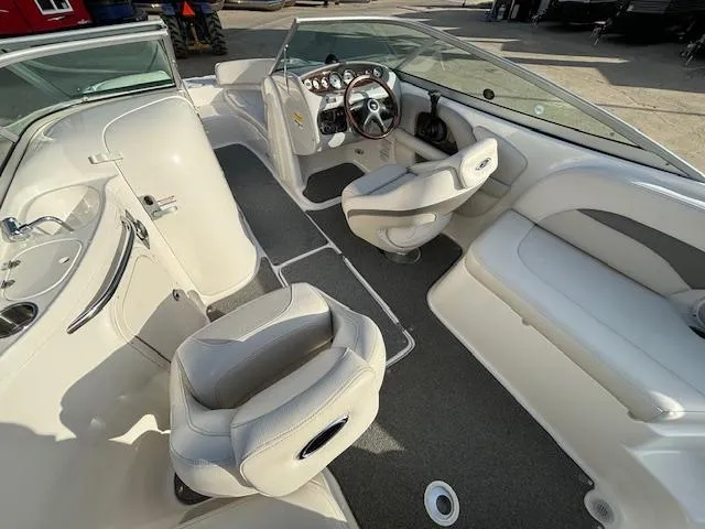 Slide: The Image of Interior of 2005 Chaparral 216 SUNSETTA boat with white seating and steering console. - 20