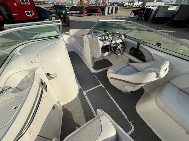 Slide: The Image of 2005 Chaparral 216 Sunsetta boat interior with steering wheel and seating. - 21