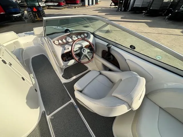 Slide: The Image of 2005 Chaparral 216 SUNSETTA boat interior with steering wheel and seating. - 22