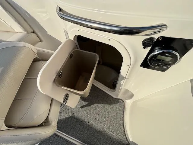 Slide: The Image of Chaparral 216 SUNSETTA 2005 boat interior with storage compartment and beige seating. - 25