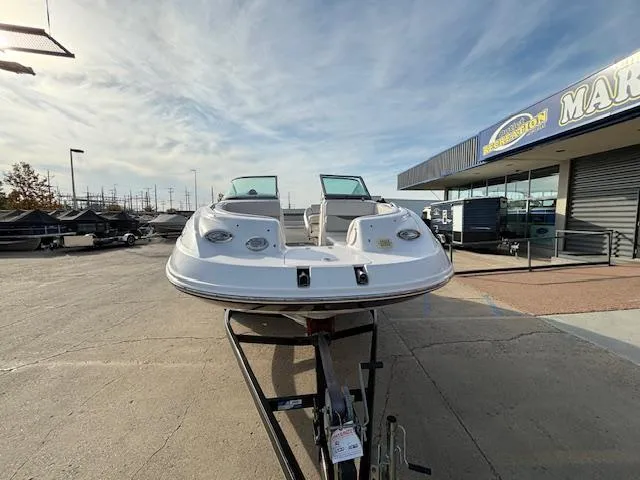 Slide: The Image of 2005 Chaparral 216 SUNSETTA boat on trailer at marina under cloudy sky. - 5