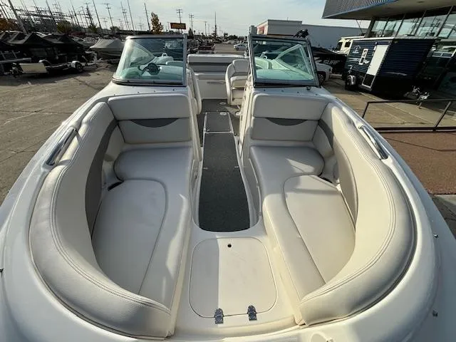 Slide: The Image of 2005 Chaparral 216 SUNSETTA boat interior with white seating and open deck. - 6