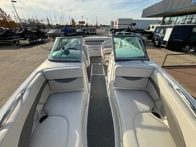 Slide: The Image of 2005 Chaparral 216 SUNSETTA boat interior with white seating and open bow design. - 7