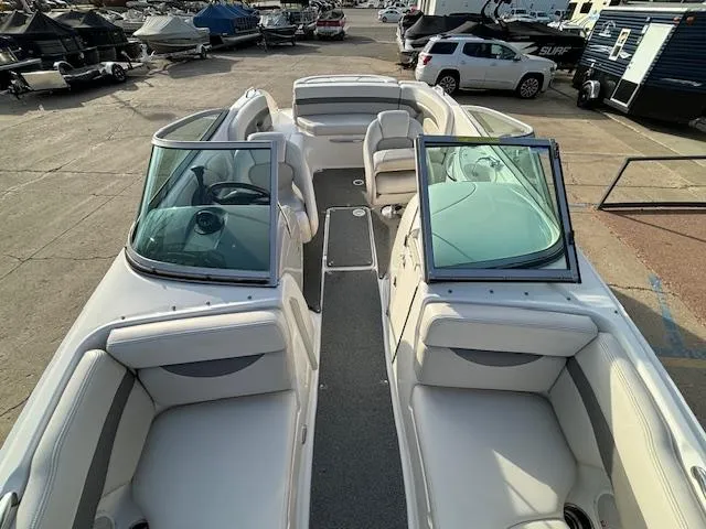Slide: The Image of 2005 Chaparral 216 SUNSETTA boat interior with white seating and open windshield. - 8