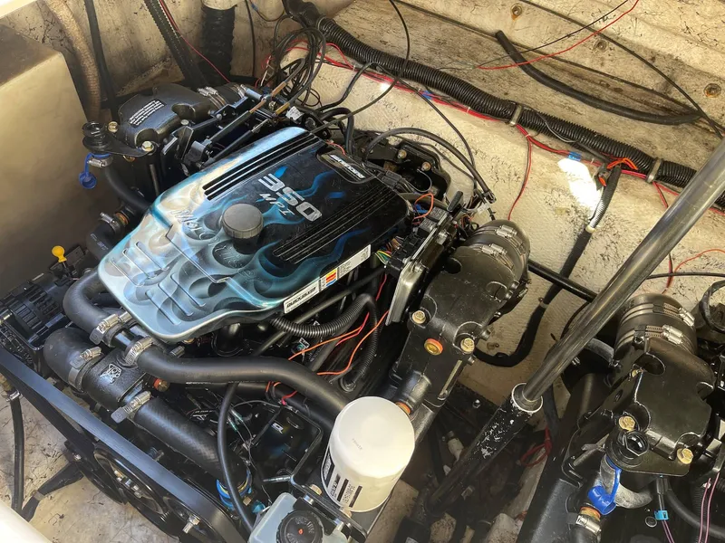 Slide: The Image of Engine compartment of a 2001 Rinker 310 Fiesta Vee boat. - 12