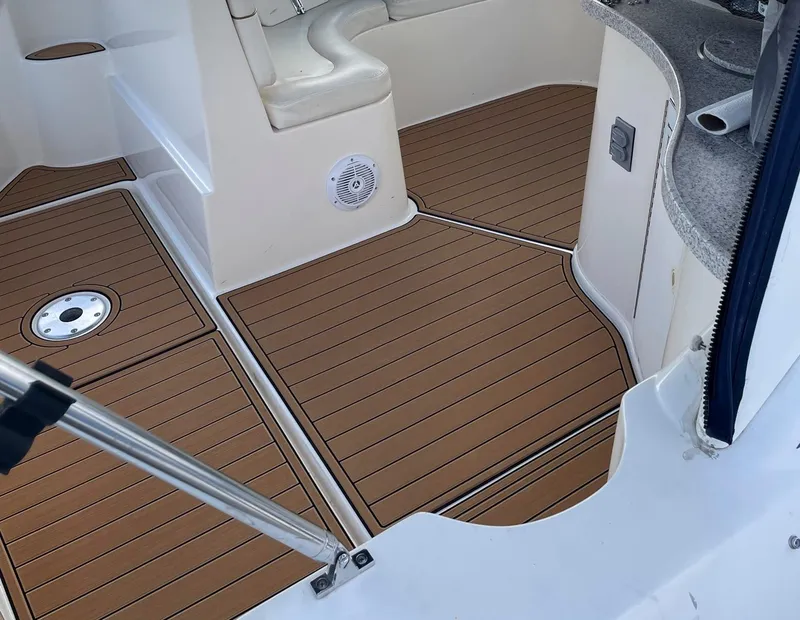 Slide: The Image of 2001 Rinker 310 Fiesta Vee boat interior with teak flooring and seating area. - 5