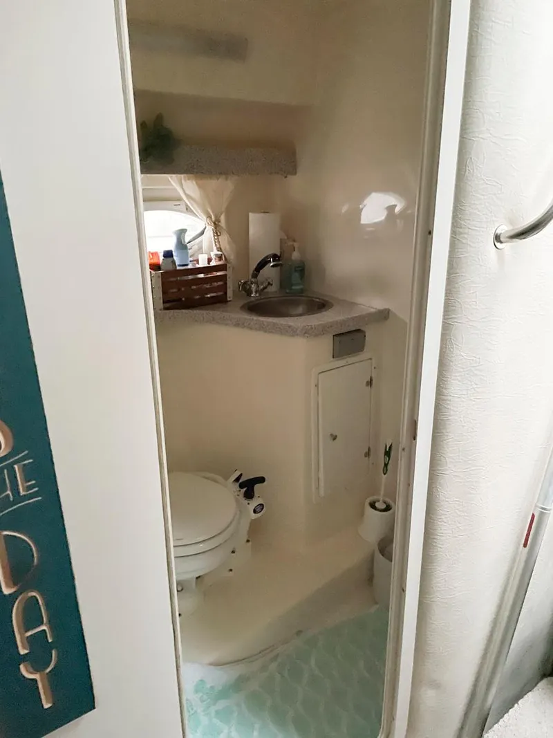 Slide: The Image of Compact bathroom in 2001 Rinker 310 Fiesta Vee boat with sink and toilet. - 7