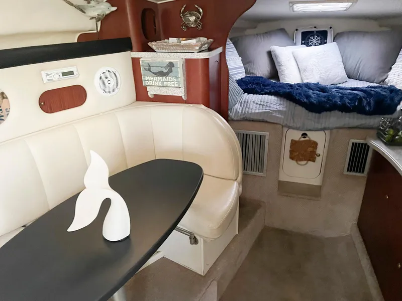 Slide: The Image of Interior of 2001 Rinker 310 Fiesta Vee boat with cozy seating and sleeping area. - 8