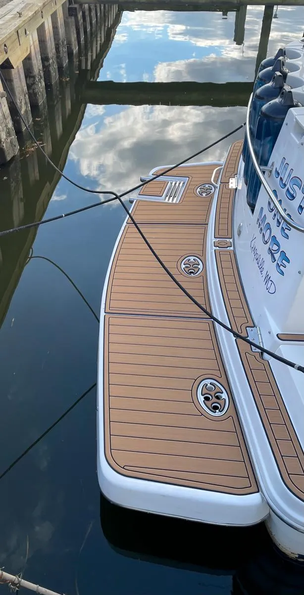 Slide: The Image of 2001 Rinker 310 Fiesta Vee boat docked with teak swim platform. - 9