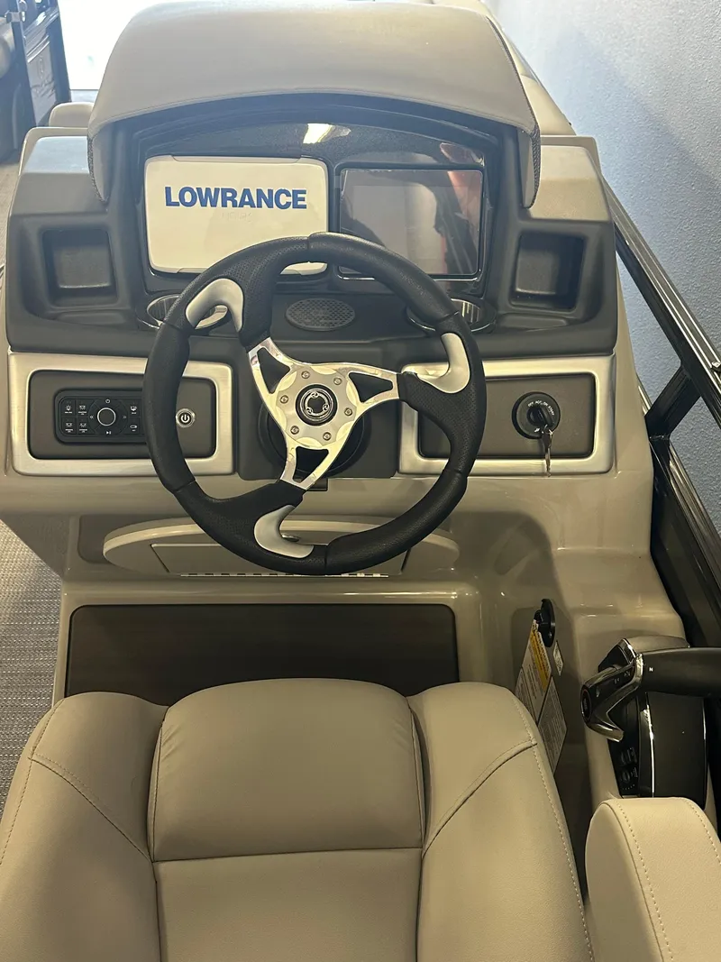 Slide: The Image of 2024 Regency 250 DL3 boat dashboard with Lowrance navigation system. - 2