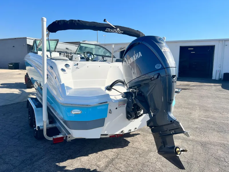 Slide: The Image of 2024 NauticStar 223DC boat with Yamaha 200 engine on trailer. - 3