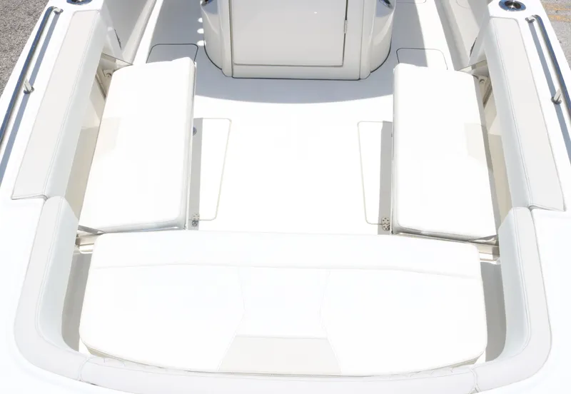 Slide: The Image of 2025 World Cat 235TE boat interior with white cushioned seating. - 10