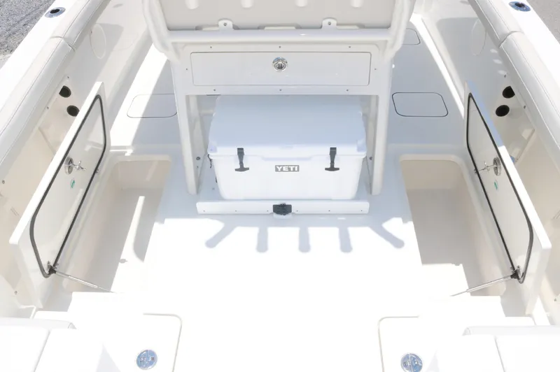 Slide: The Image of 2025 World Cat 235TE boat interior with storage compartments and Yeti cooler. - 12