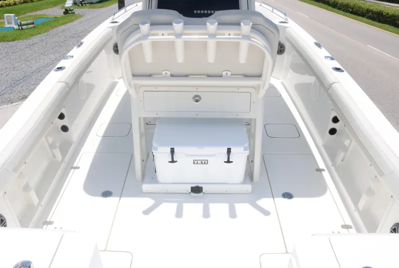 Slide: The Image of 2025 World Cat 235TE boat interior with Yeti cooler and rod holders. - 13
