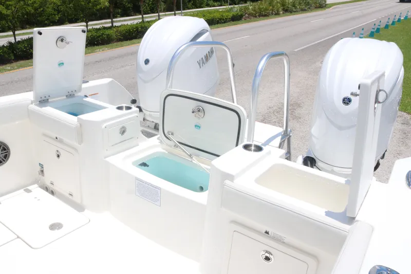Slide: The Image of 2025 World Cat 235TE boat with Yamaha engines and multiple storage compartments. - 16